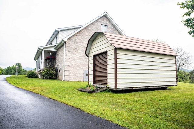 view of side of home featuring a yard