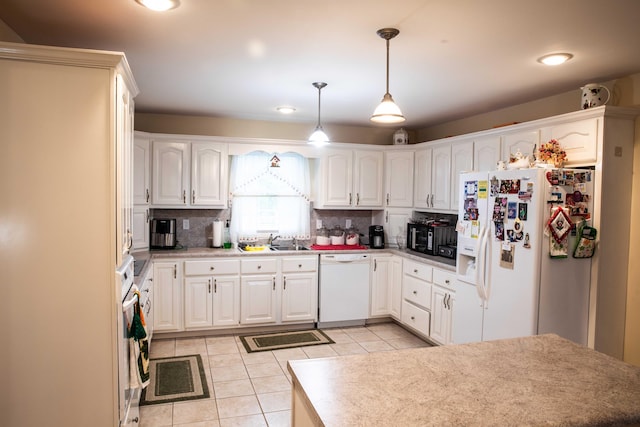 kitchen with backsplash, white appliances, light tile floors, and hanging light fixtures