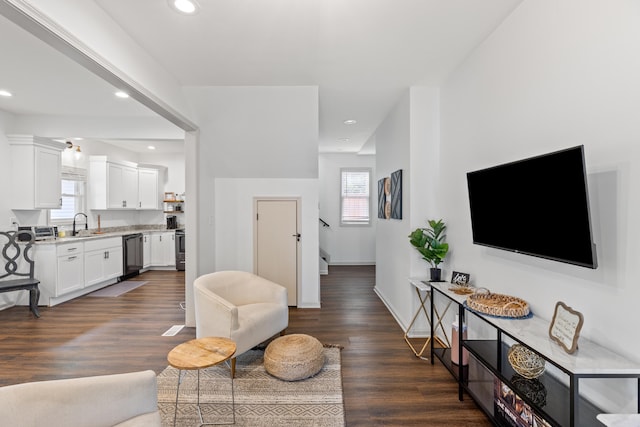 living room with a healthy amount of sunlight and dark wood-type flooring