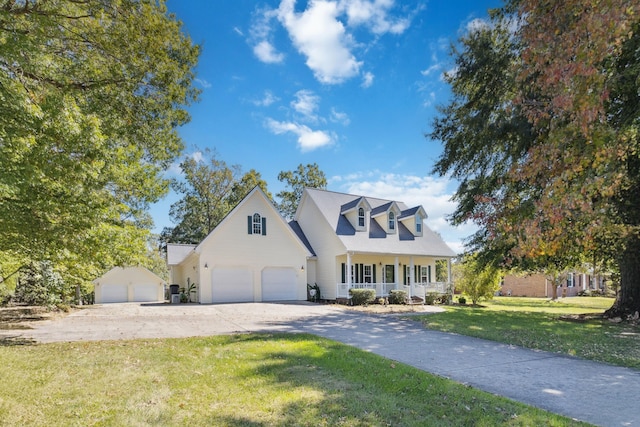 cape cod home with a front lawn, covered porch, and a garage