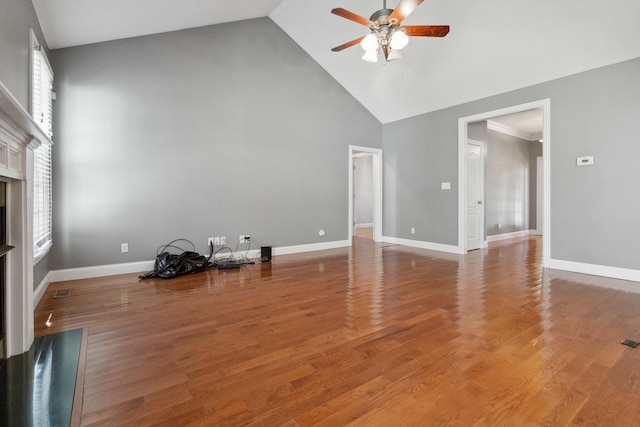 unfurnished living room featuring wood-type flooring, high vaulted ceiling, and ceiling fan