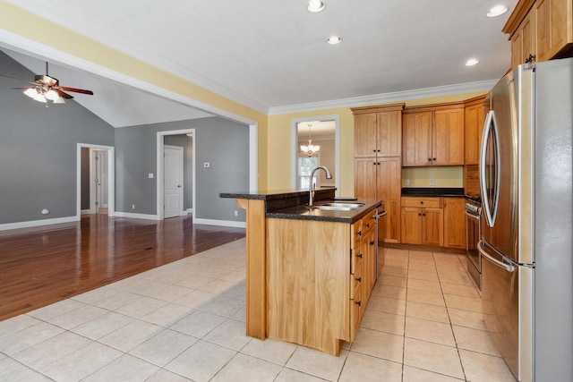 kitchen featuring a center island with sink, appliances with stainless steel finishes, light hardwood / wood-style flooring, ornamental molding, and sink