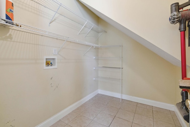 laundry room with washer hookup and tile patterned flooring