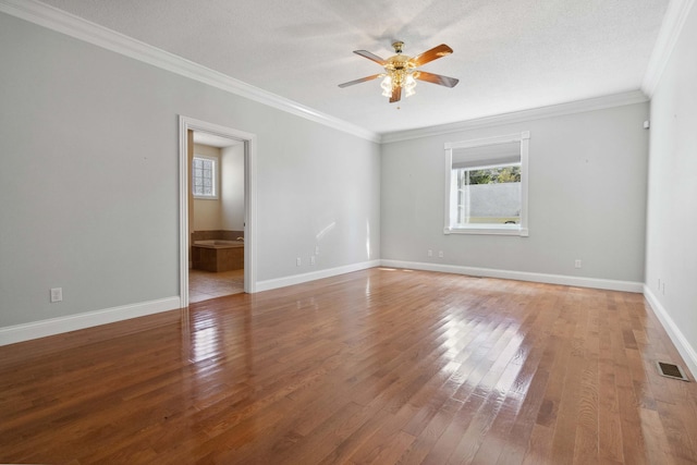 spare room featuring crown molding, wood-type flooring, a textured ceiling, and ceiling fan