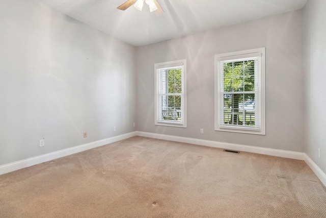 carpeted empty room featuring ceiling fan