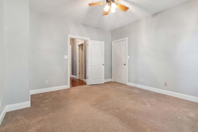 carpeted empty room featuring ceiling fan