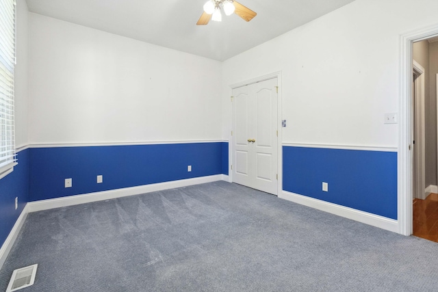 empty room with carpet flooring and ceiling fan