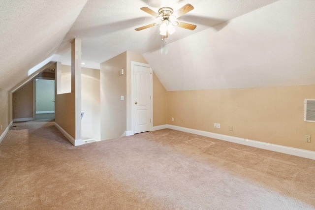 bonus room featuring a textured ceiling, carpet, and lofted ceiling