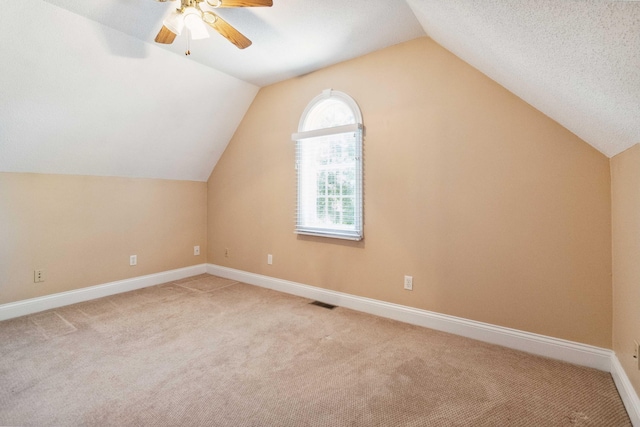 bonus room with vaulted ceiling, light carpet, and a wealth of natural light