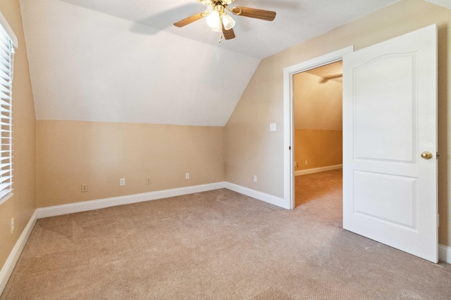 bonus room featuring light carpet, lofted ceiling, and ceiling fan