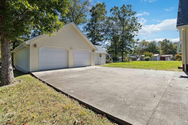 view of side of property featuring an outdoor structure, a yard, and a garage