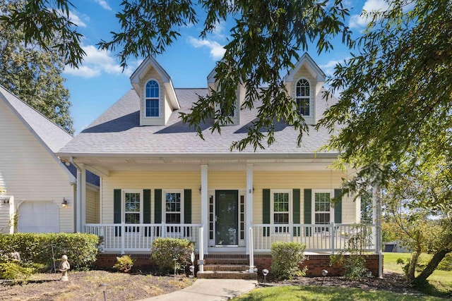 view of front facade featuring covered porch and a garage