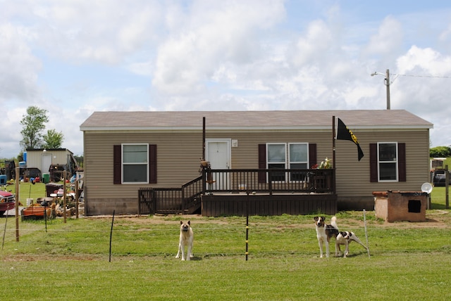 view of front of home featuring a deck and a front lawn