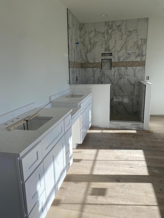 bathroom with hardwood / wood-style flooring and sink