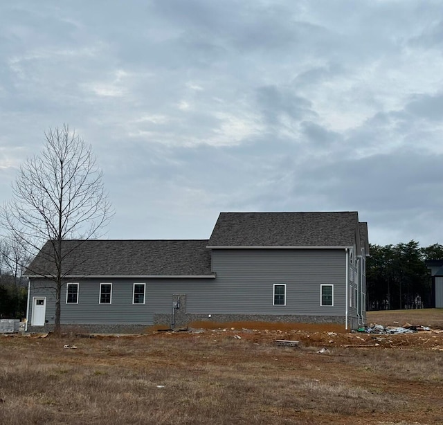 exterior space with roof with shingles