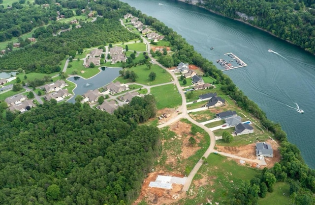 aerial view with a residential view, a water view, and a wooded view