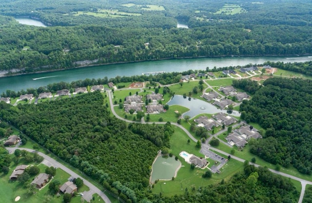 bird's eye view featuring a forest view and a water view