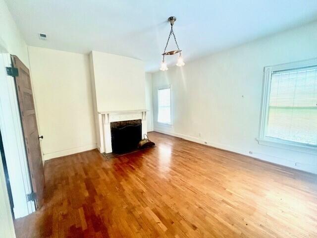 unfurnished living room with wood-type flooring