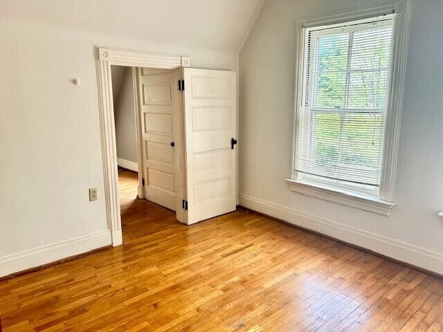 bonus room featuring vaulted ceiling and light wood-type flooring