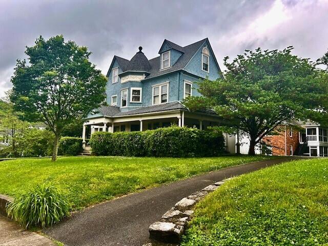 victorian house featuring a front lawn