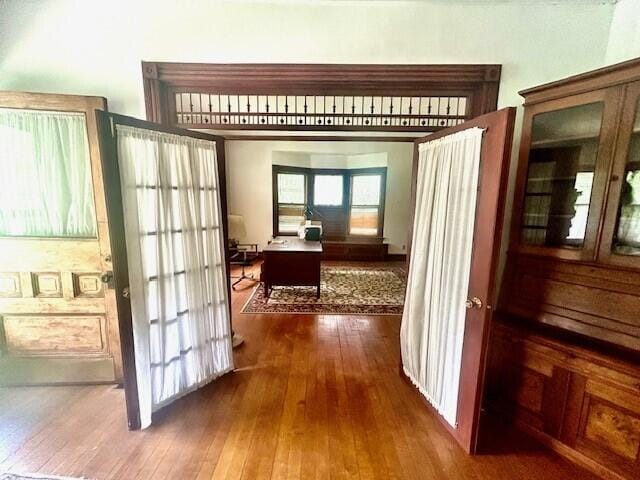 hallway with hardwood / wood-style floors