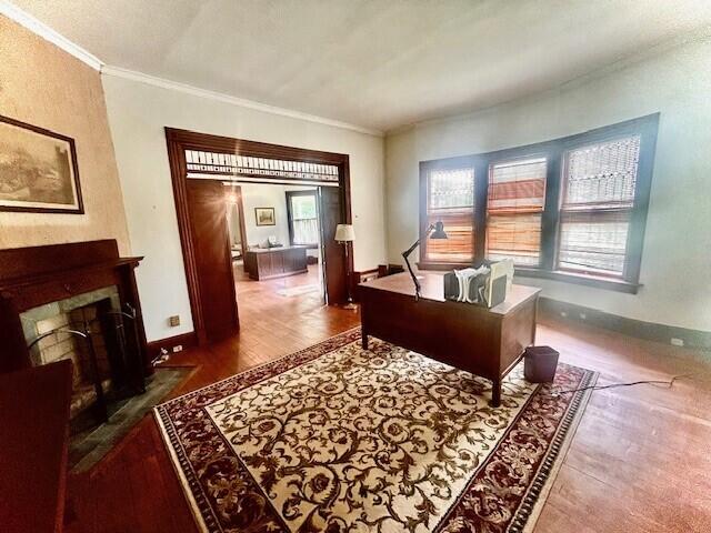 sitting room with plenty of natural light, hardwood / wood-style flooring, and ornamental molding