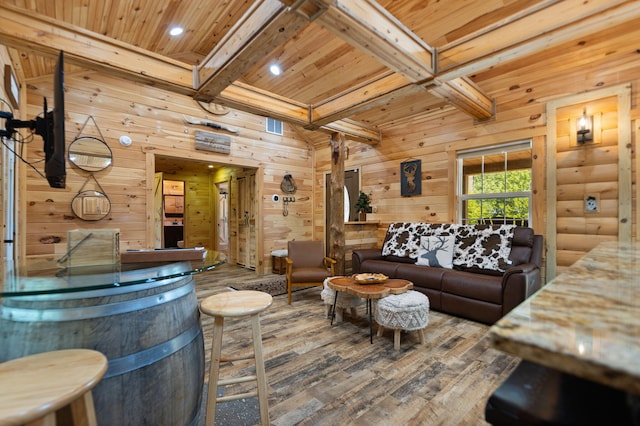 living room with beamed ceiling, wooden walls, hardwood / wood-style flooring, and wood ceiling