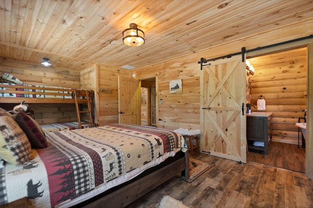 bedroom with rustic walls, a barn door, dark hardwood / wood-style floors, and wood ceiling