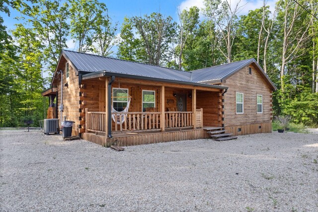 log cabin featuring central air condition unit and covered porch