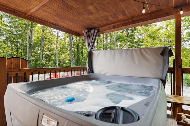 wooden deck featuring a hot tub