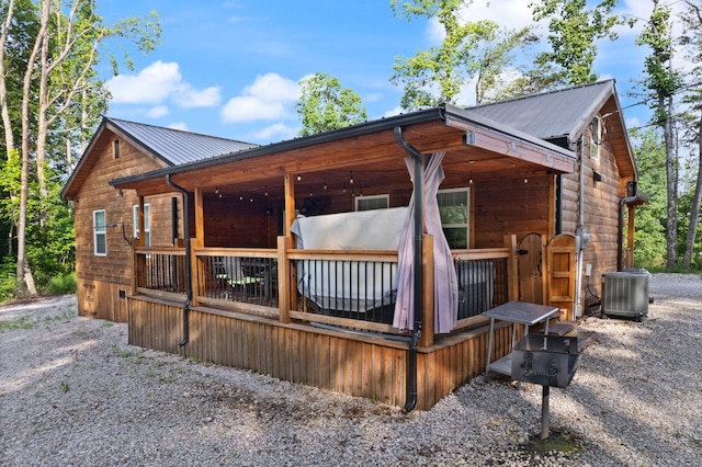 view of side of home with a deck and central air condition unit