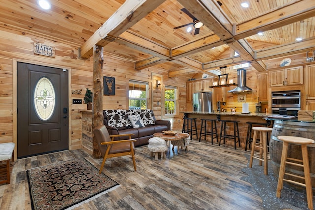 living room with beam ceiling, wood ceiling, wood-type flooring, and wood walls