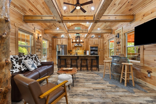 living room with beamed ceiling, coffered ceiling, light wood-type flooring, and wood ceiling