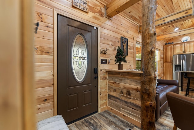 foyer with wooden ceiling, beam ceiling, hardwood / wood-style flooring, and wood walls