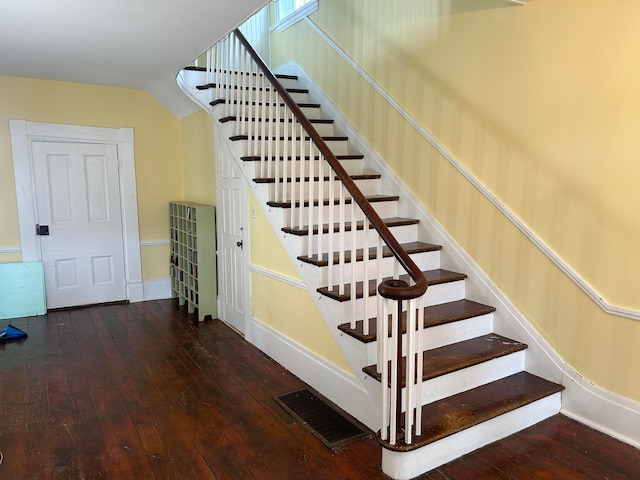 staircase with hardwood / wood-style floors