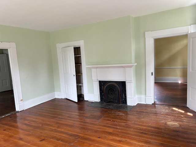 unfurnished living room featuring dark hardwood / wood-style floors