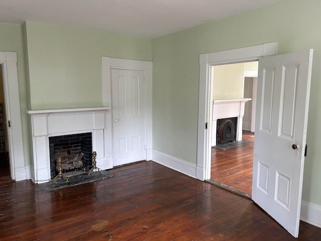 unfurnished living room with wood-type flooring