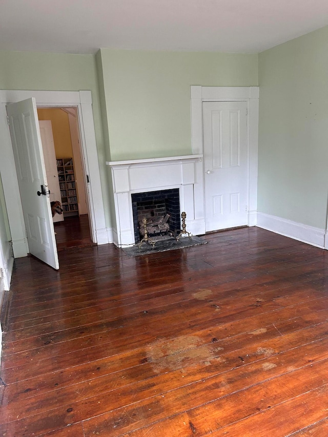 unfurnished living room featuring dark hardwood / wood-style flooring