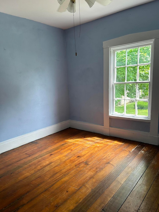 unfurnished room with ceiling fan and wood-type flooring