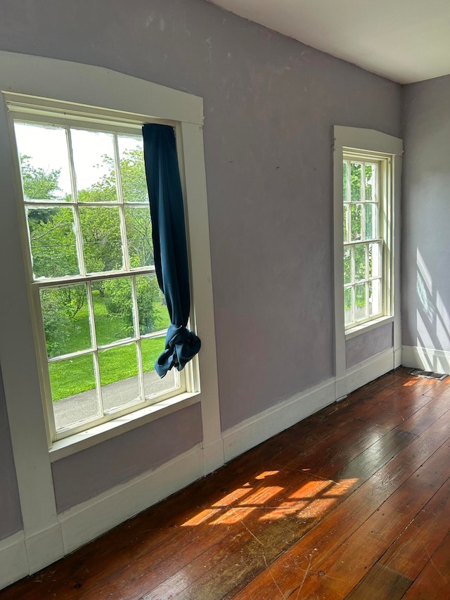 unfurnished room with hardwood / wood-style flooring