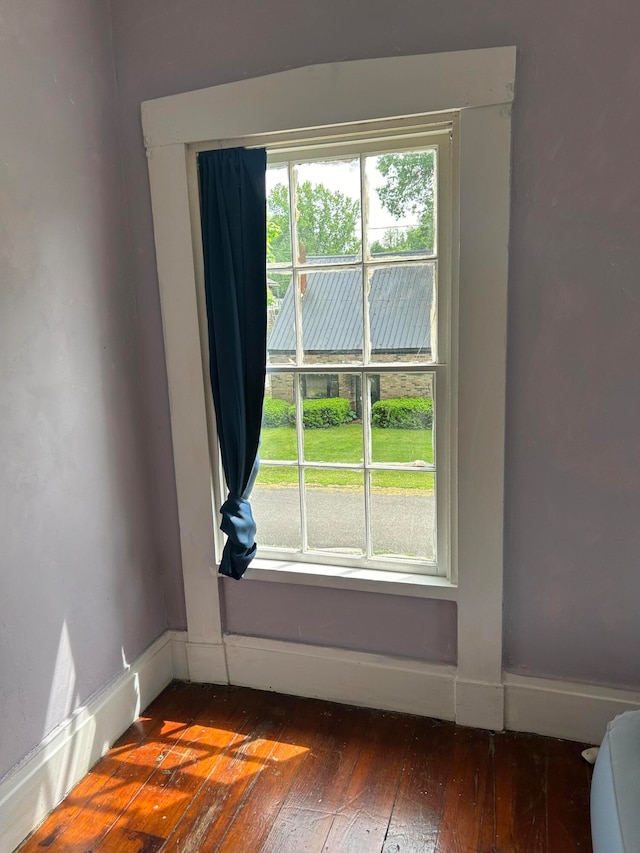 unfurnished room featuring a healthy amount of sunlight and hardwood / wood-style floors