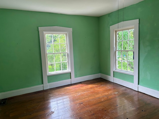 spare room featuring dark wood-type flooring