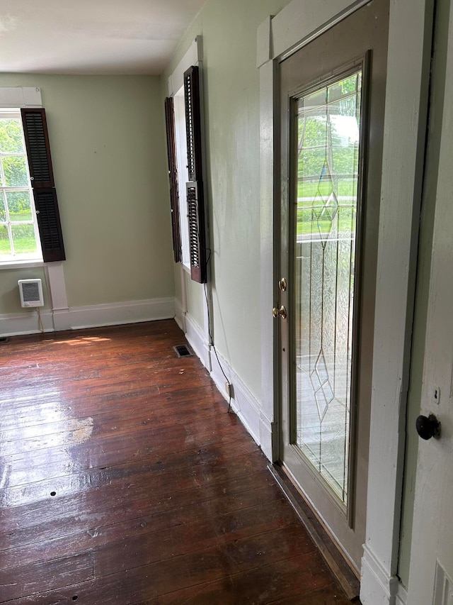 entryway with dark hardwood / wood-style flooring and an AC wall unit