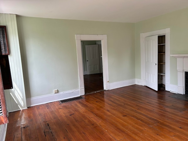 unfurnished bedroom featuring a closet and dark hardwood / wood-style flooring