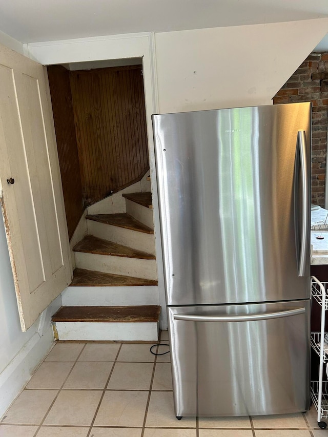 stairway featuring light tile flooring