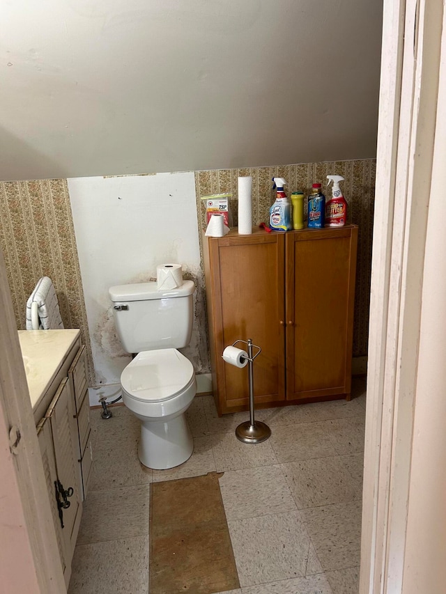 bathroom with tile floors, vanity, and toilet