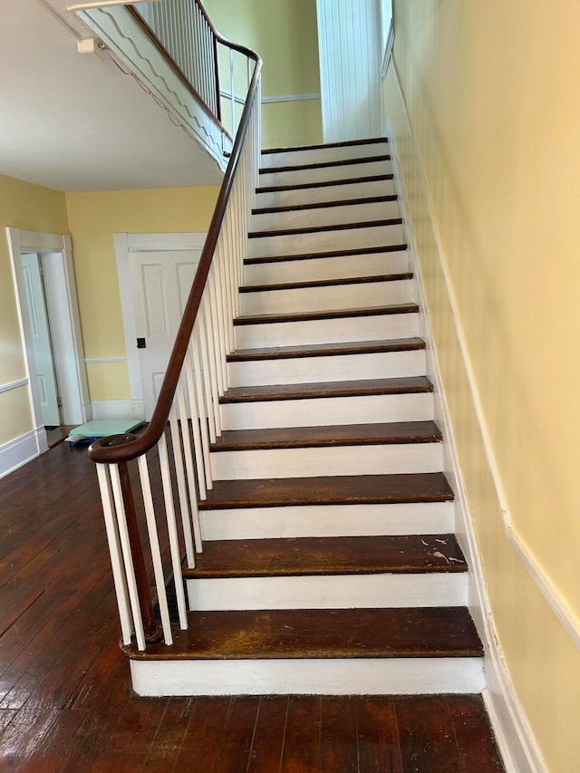 staircase with dark wood-type flooring