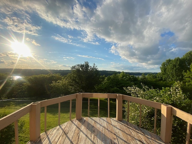 wooden deck featuring a lawn