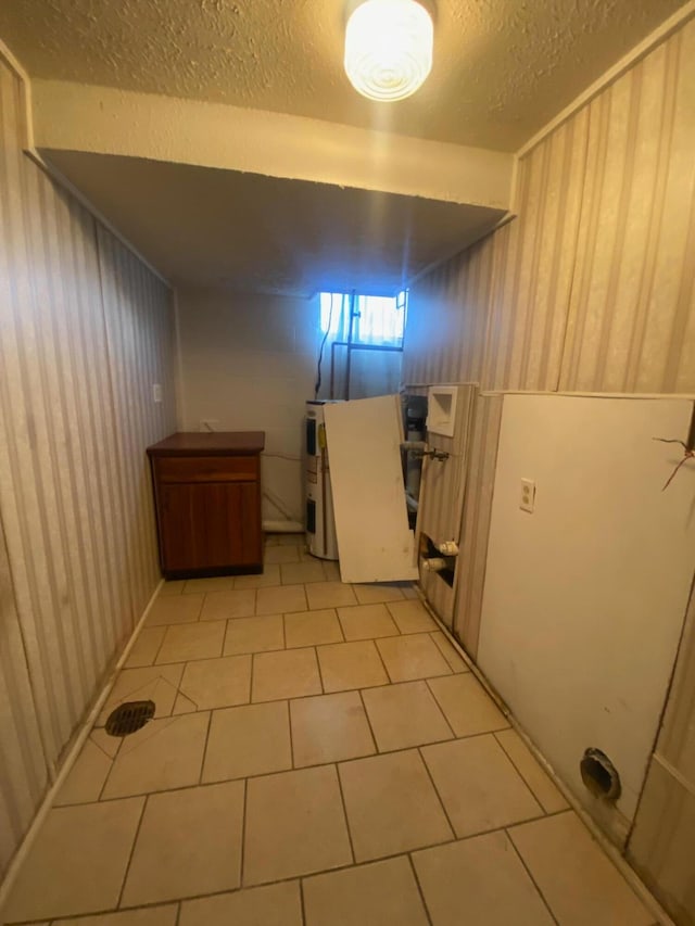 interior space with light tile patterned floors and a textured ceiling