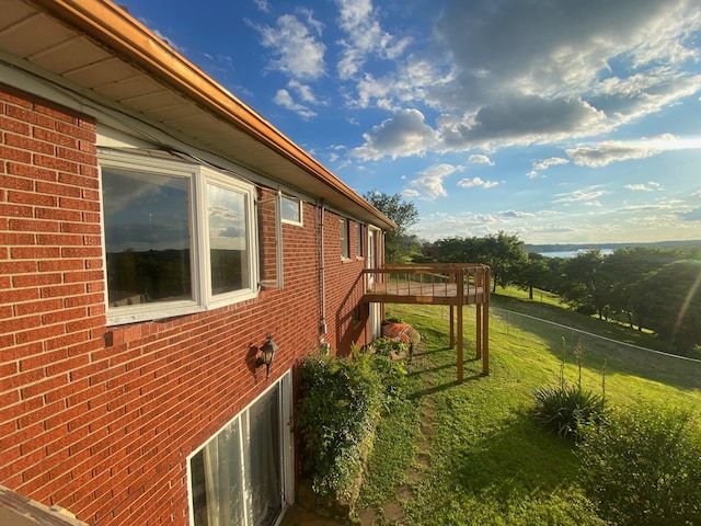 view of home's exterior featuring a wooden deck and a yard